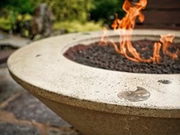 A conical fire pit made of polished concrete